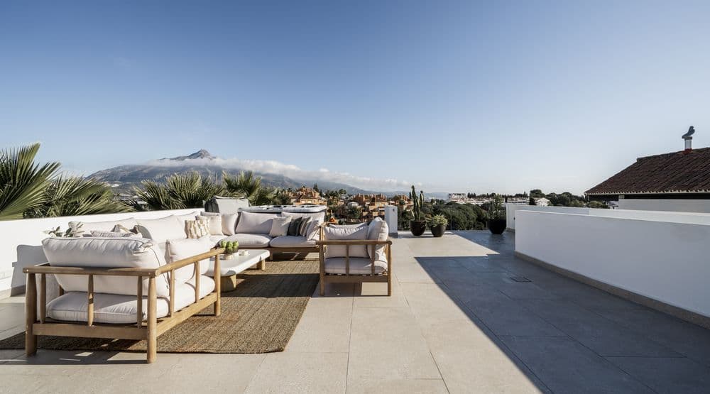 Rooftop lounge terrace with sofas facing La Concha mountain and the pool edge