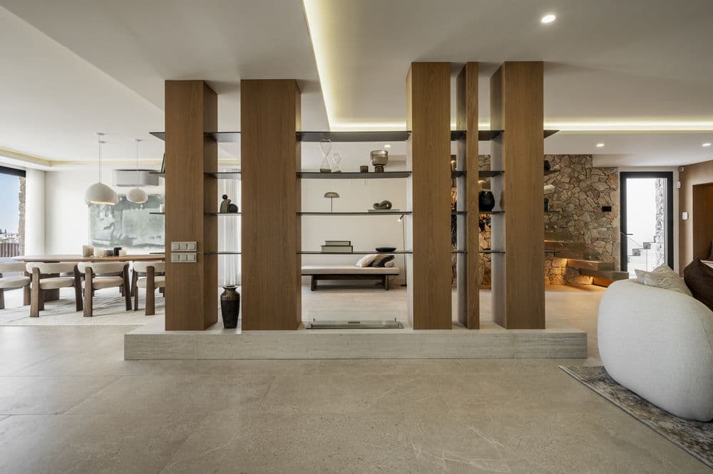 Open-plan interior with a wood column room divider, dining nook and fireplace corner